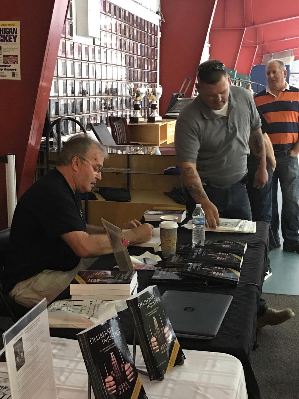Ken at the signing table with his nephew TJ